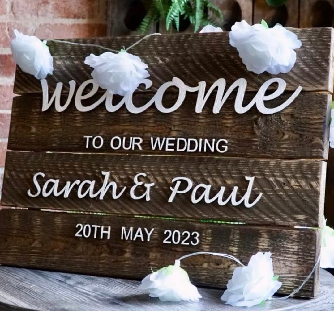 Wooden bridge and groom welcome sign